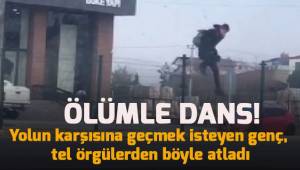 Tel örgülerine tırmanıp canını hiçe sayarak yolun karşısına geçti