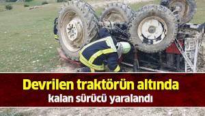Devrilen traktörün altında kalan sürücü yaralandı