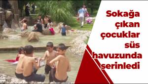 Sokağa çıkan çocuklar süs havuzunda serinledi