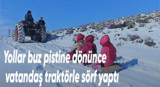 Yollar buz pistine dönünce vatandaş traktörle sörf yaptı