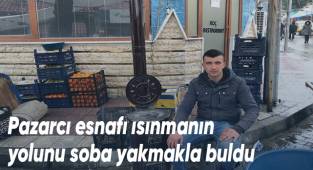Pazarcı esnafı ısınmanın yolunu soba yakmakla buldu