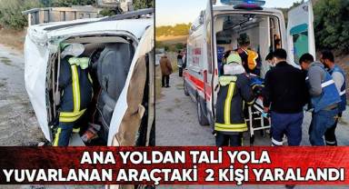 Ana yoldan tali yola yuvarlanan araçtaki 2 kişi yaralandı