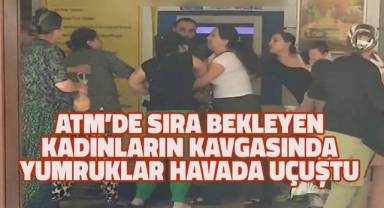 Ringe dönüşen ATM'deki kavgaya aldırış etmeden parasını çekmeye devam etti