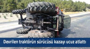 Devrilen traktörün sürücüsü kazayı ucuz atlattı